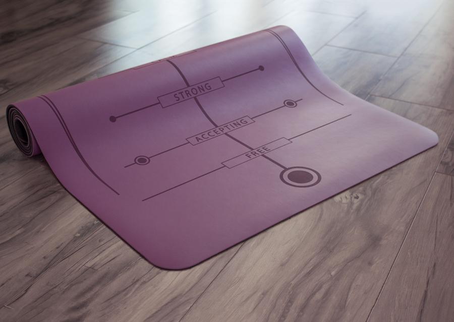 Partially rolled purple yoga mat on floor