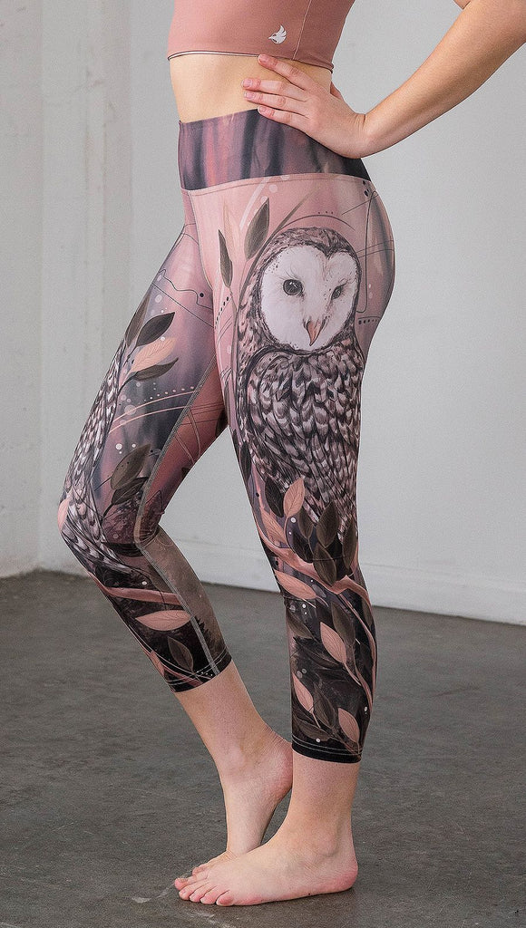 closeup left side view of model wearing owl themed capri leggings