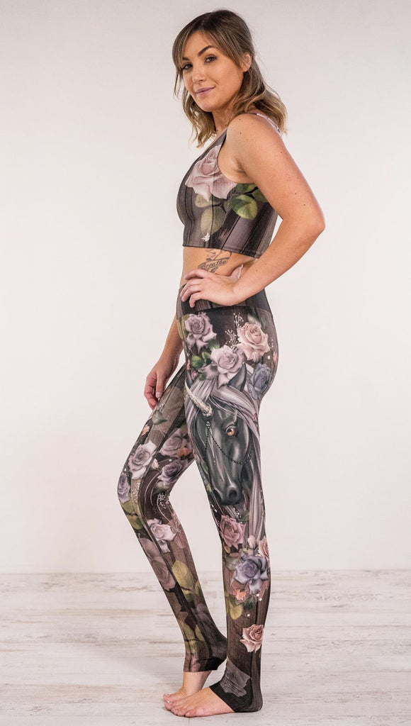 Side view of model wearing unicorn and rose printed full length leggings