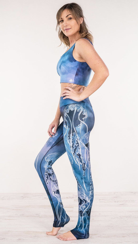 Left side view of model wearing jellyfish themed printed full length leggings