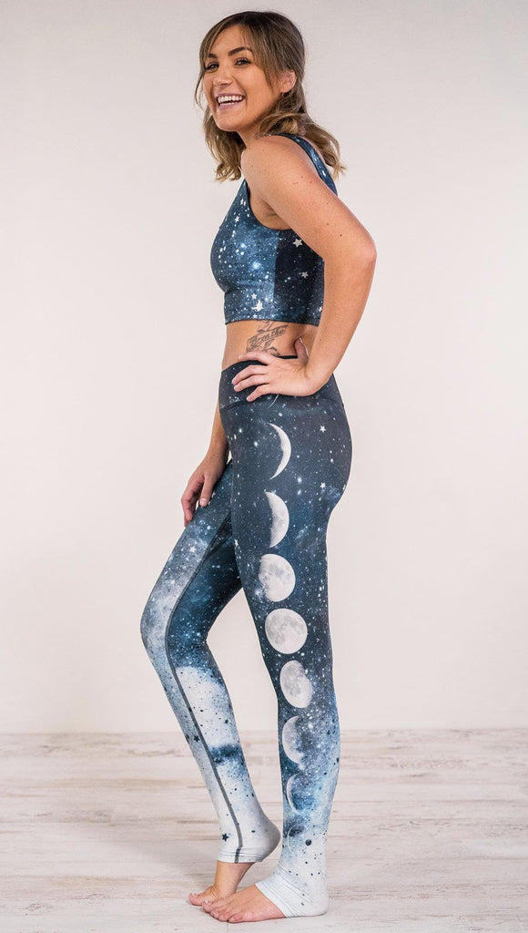 Left side view of model wearing moon cycle themed full length leggings