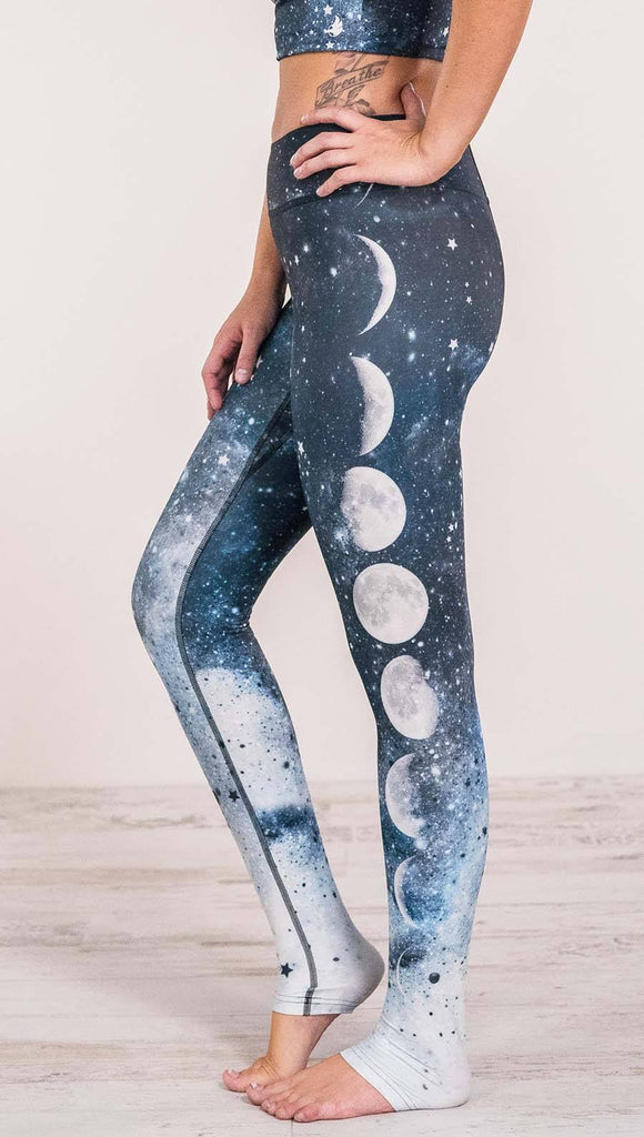 Close up left side view of model wearing moon cycle themed full length leggings