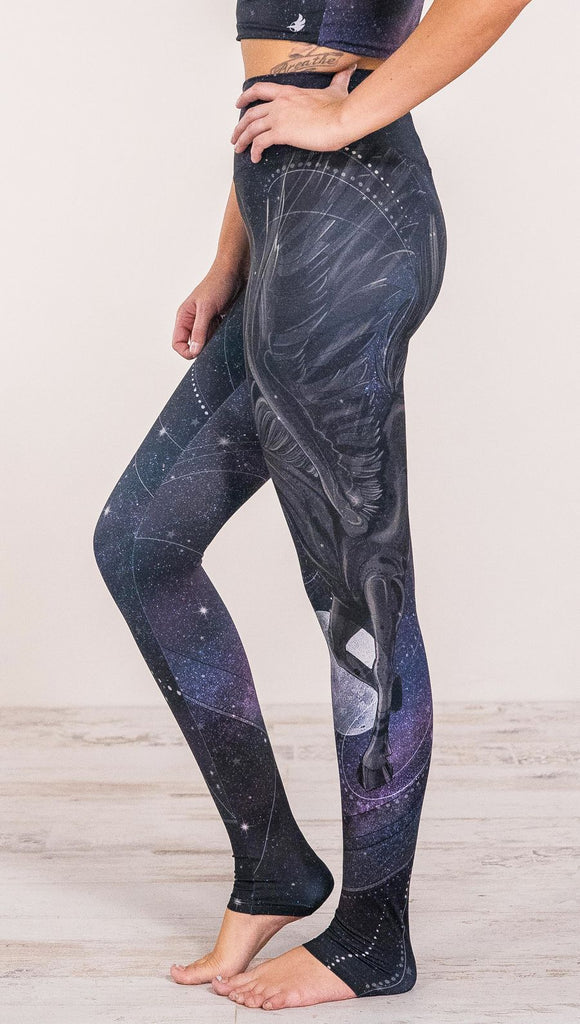 Close up side view of model wearing fantasy flying pegasus themed printed full length leggings