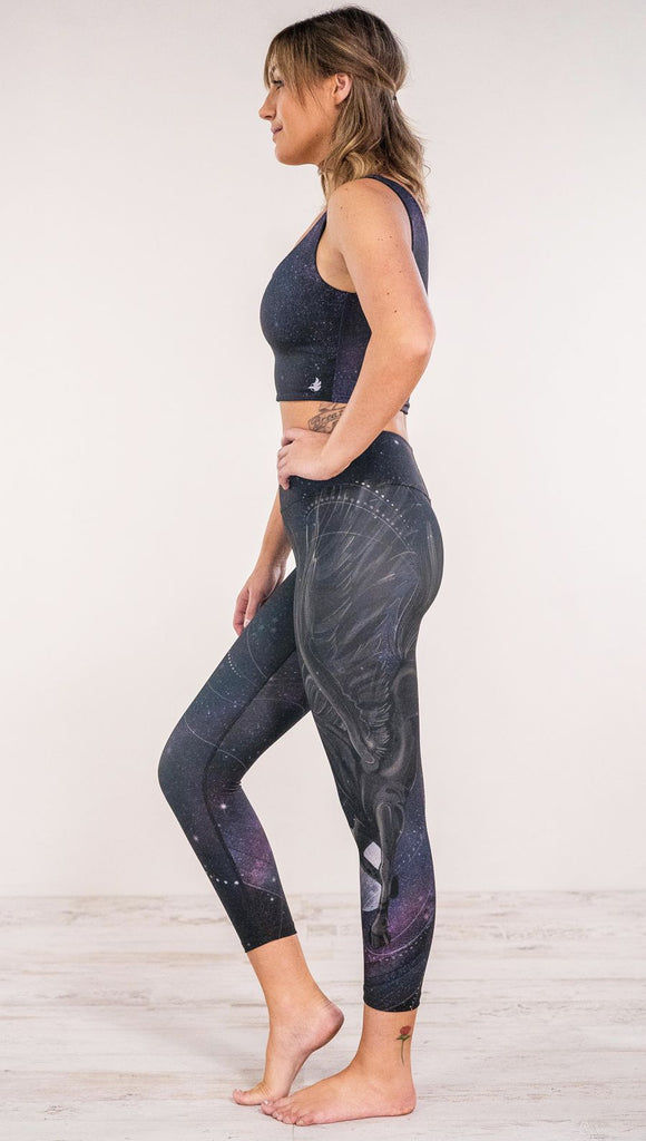 Side view of model wearing fantasy flying pegasus themed printed leggings