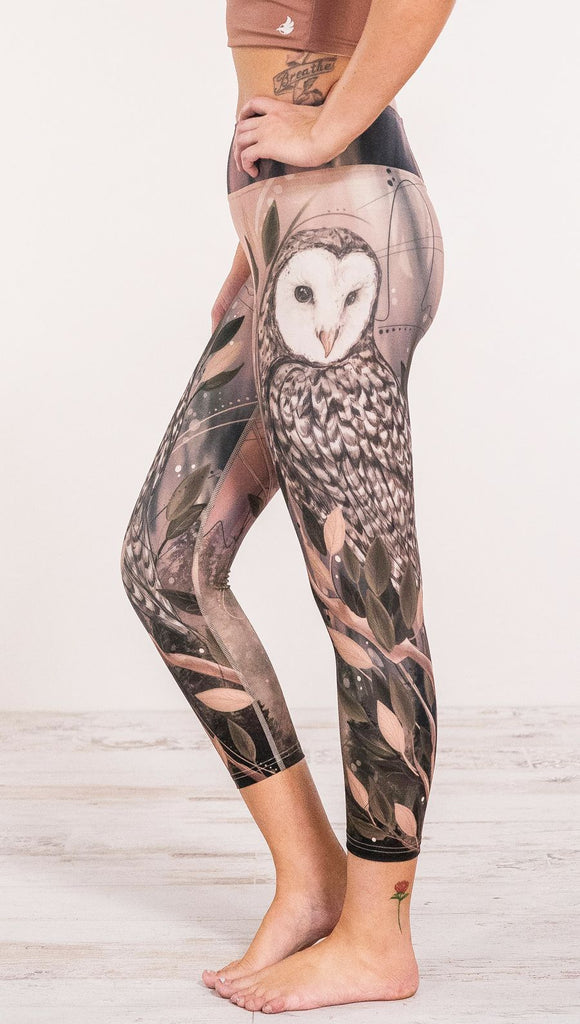 Close up side view of model wearing owl themed leggings