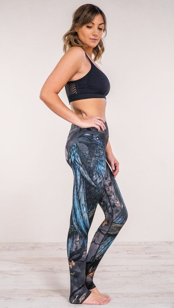 Right side view of model wearing gothic themed printed full length leggings