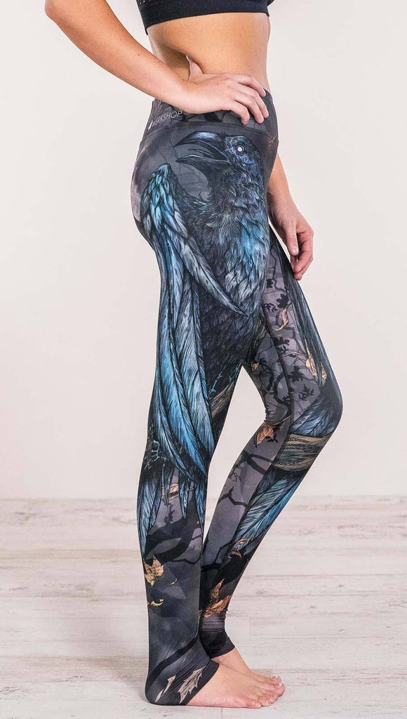 Close up right side view of model wearing gothic themed printed full length leggings