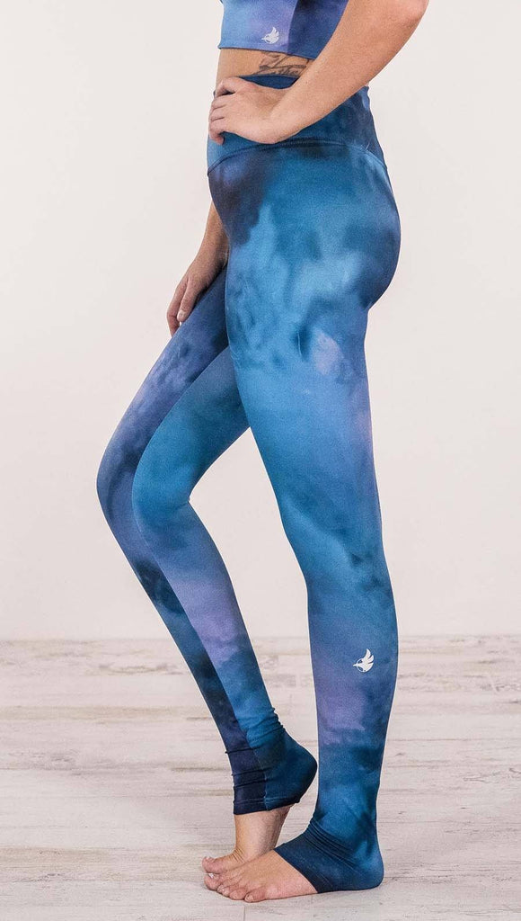 Close up left side view of model wearing full length leggings with tanzanite watercolor printed design