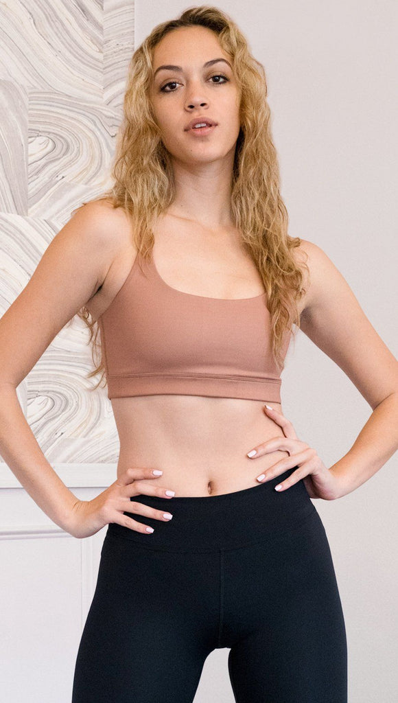front view of model wearing brown cinnamon colored sports bra