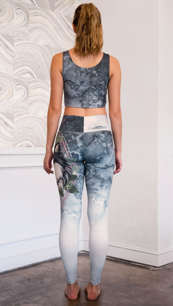 back view of model wearing full length Finnish Lapphund artwork themed leggings