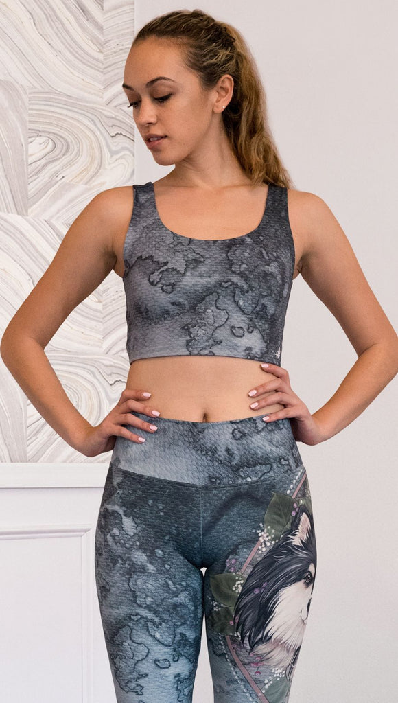 front view of model wearing watercolor artwork themed reversible sports top