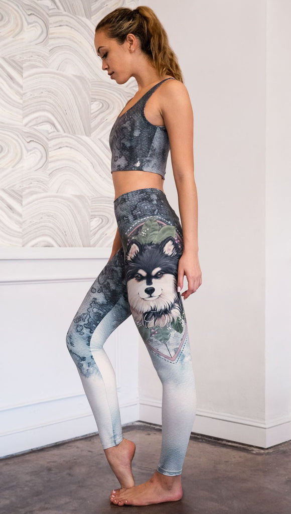 left side view of model wearing full length Finnish Lapphund artwork themed leggings
