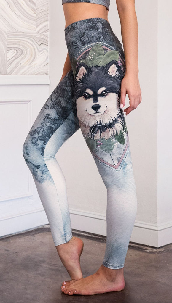 closeup left side view of model wearing full length Finnish Lapphund artwork themed leggings