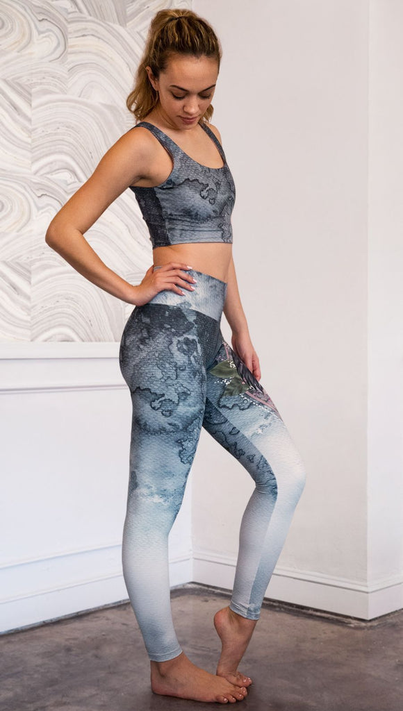 right side view of model wearing full length Finnish Lapphund artwork themed leggings