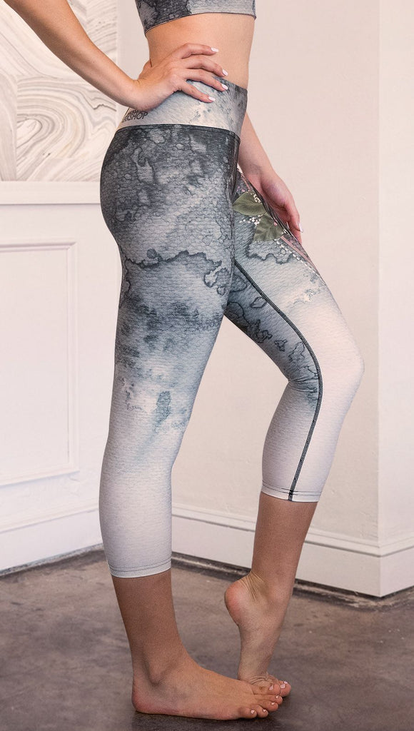 closeup right side view of model wearing capri Finnish Lapphund artwork themed leggings