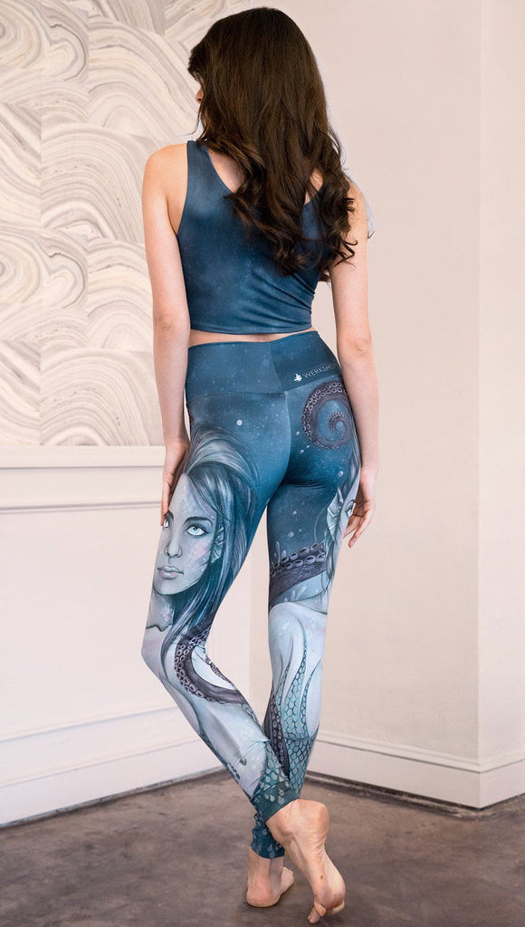 back view of model wearing full length leggings with mermaid and tentacles printed design