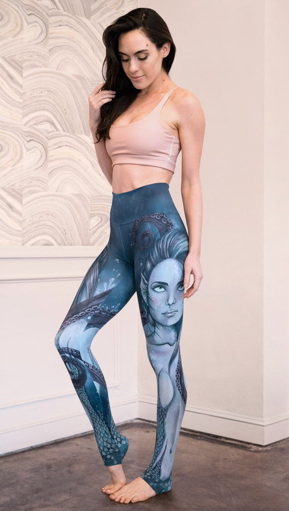 left side view of model wearing full length leggings with mermaid and tentacles printed design