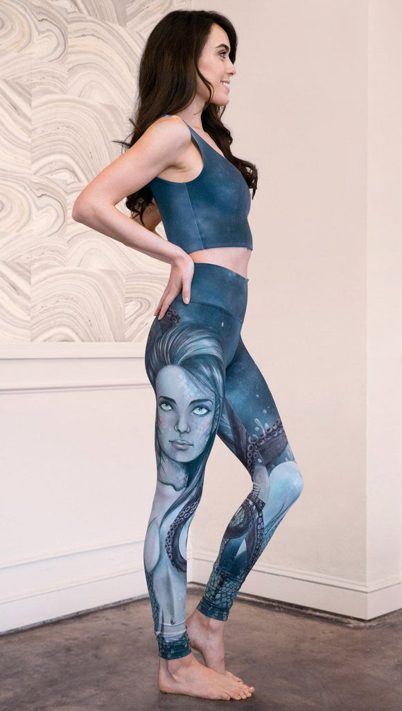 right side view of model wearing full length leggings with mermaid and tentacles printed design