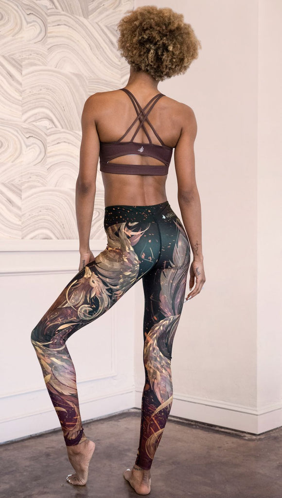 back view of model wearing phoenix themed full length leggings