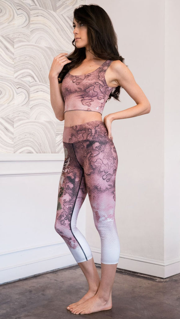 left side view of model wearing pink/mauve Icelandic Sheepdog capri leggings with Original Tattoo-Inspired artwork