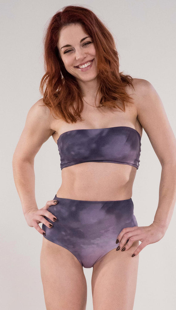 Front view of model wearing the reversible Peacock bandeau in the Peacock side in the colors purple and dark purple