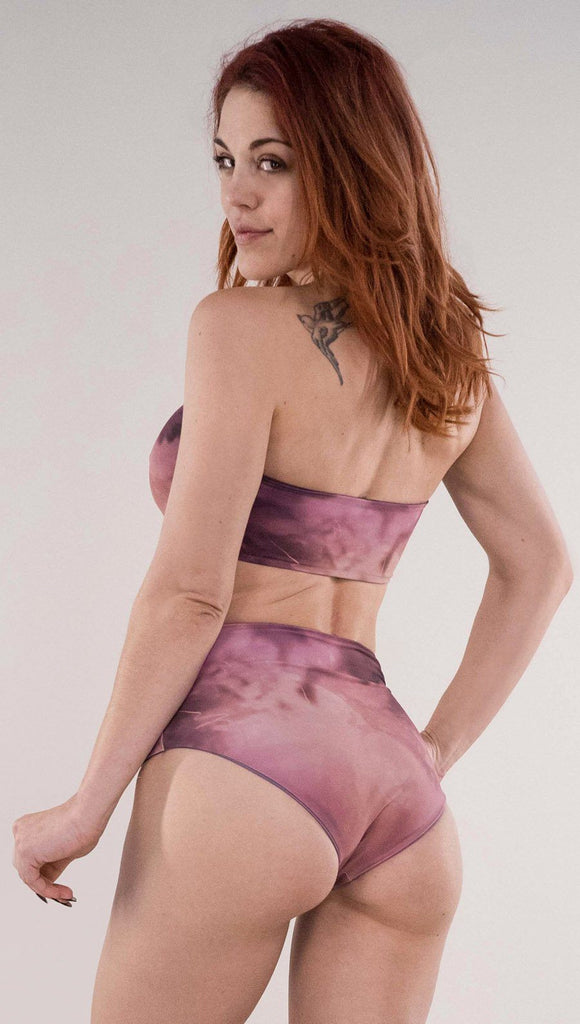 Back side view of model wearing the reversible Peacock bandeau in the Rose Quartz side in the colors pink and purple