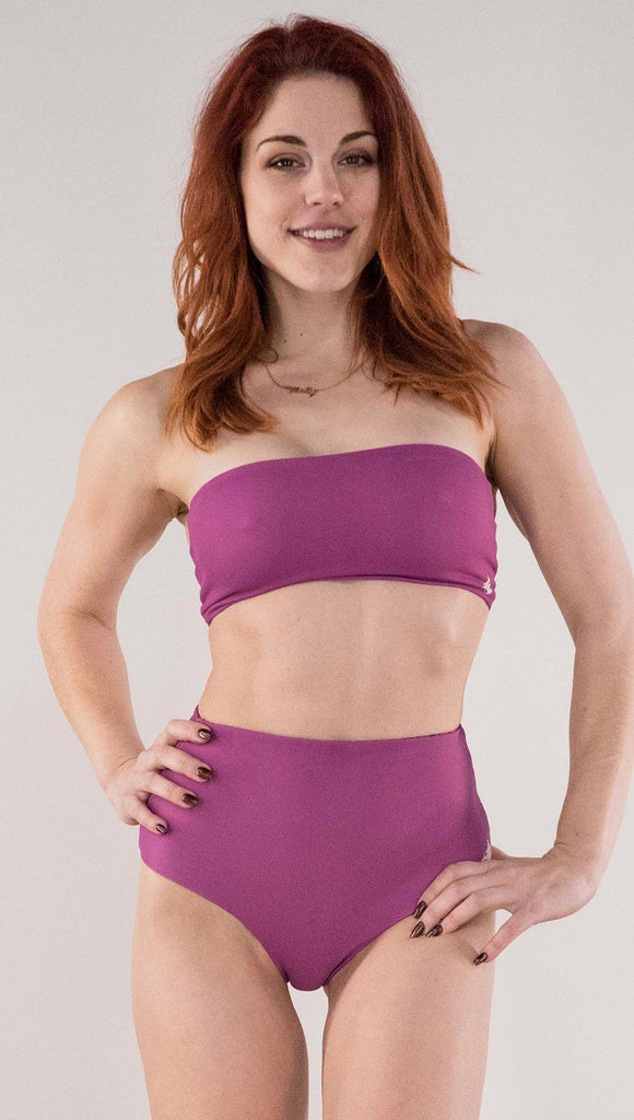 Front view of model wearing the reversible Rainbow Mosaic bandeau in the reversed fuchsia side
