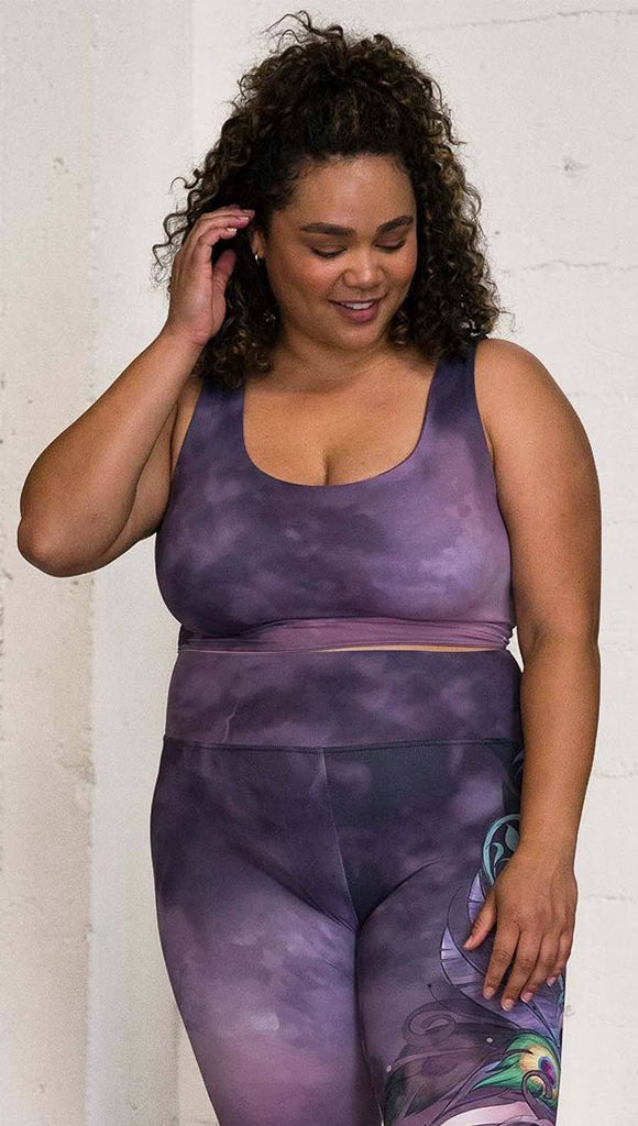 front view of model wearing watercolor inspired reversible tank top with purple on one side and mauve/pink on the other side