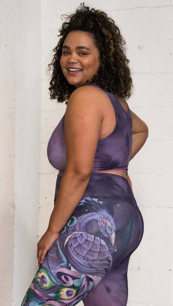 left side view of model wearing watercolor inspired reversible tank top with purple on one side and mauve/pink on the other side