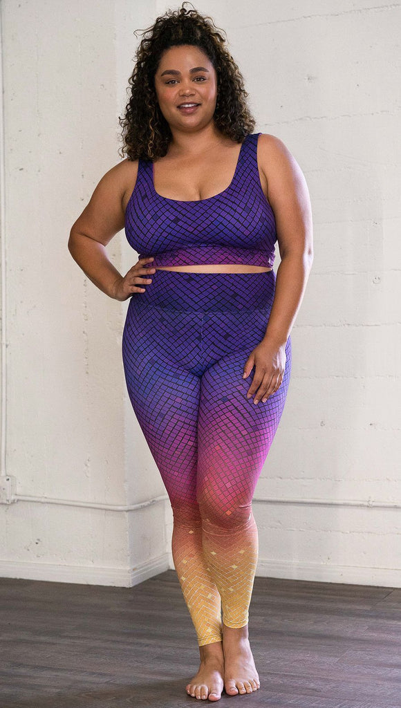 Front view of a model wearing purple/pink/yellow ombre mosaic tile print full length leggings