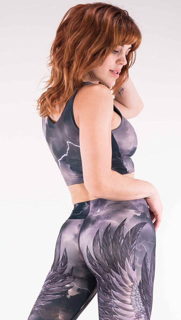 Back view of model wearing the reversible Thunder Top in a dark gray and purple with lighting strikes throughout
