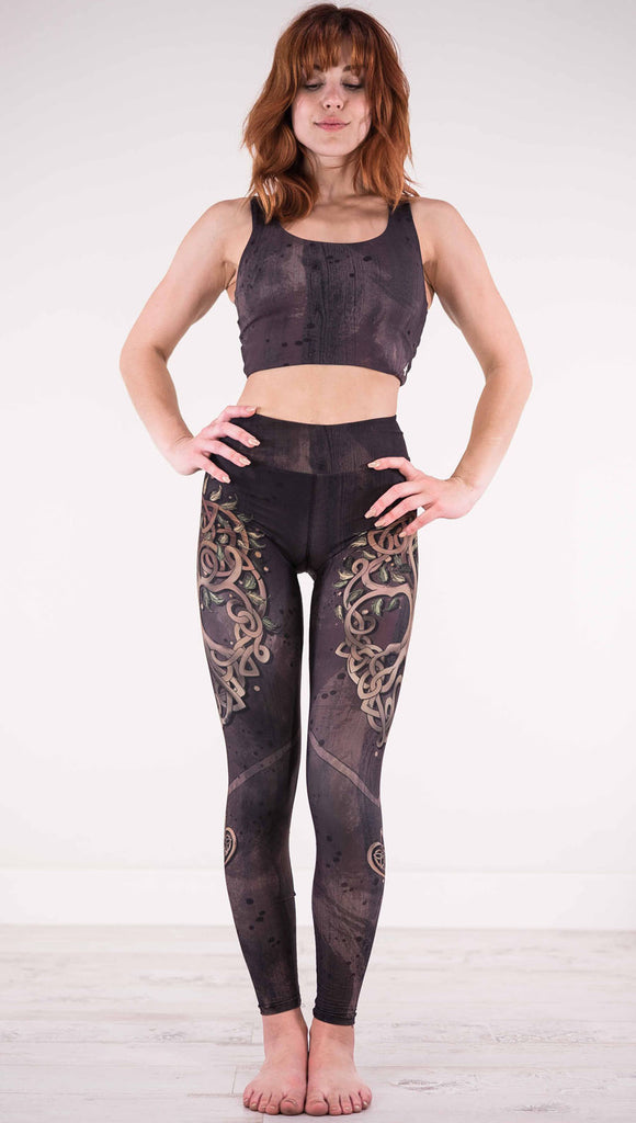 Front view of model wearing the Tree of Life triathlon leggings in a brown wood grain print with a tree on each side