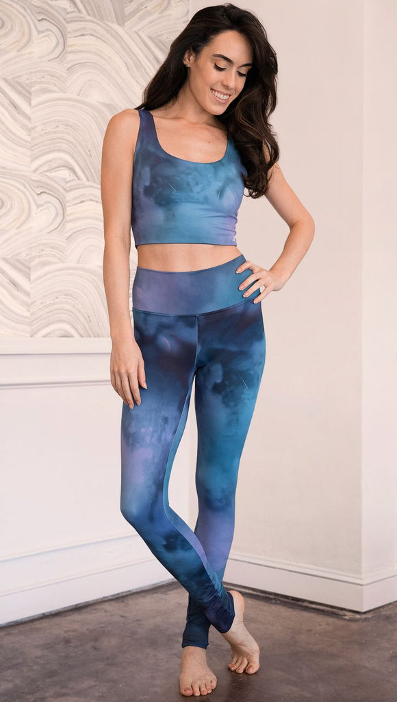 front view of model wearing full length leggings with tanzanite watercolor printed design