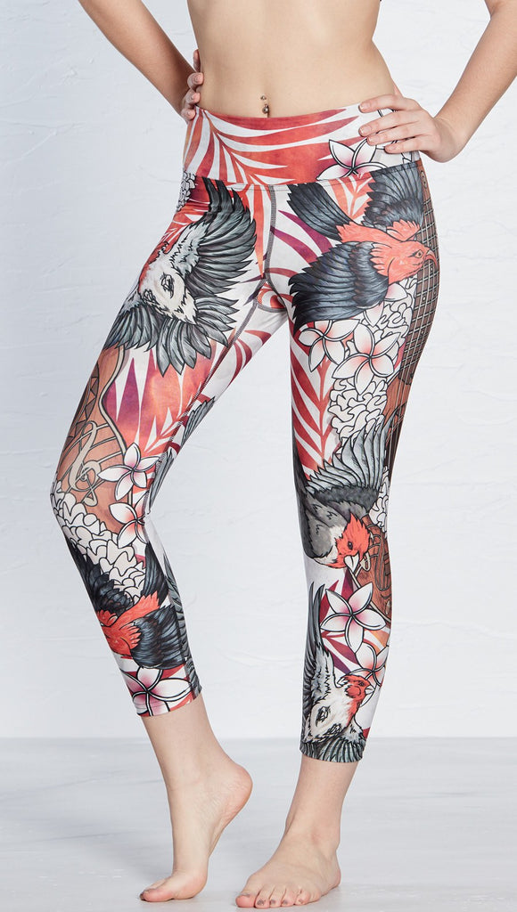 close up front view of model wearing island bird and ukulele themed printed capri leggings