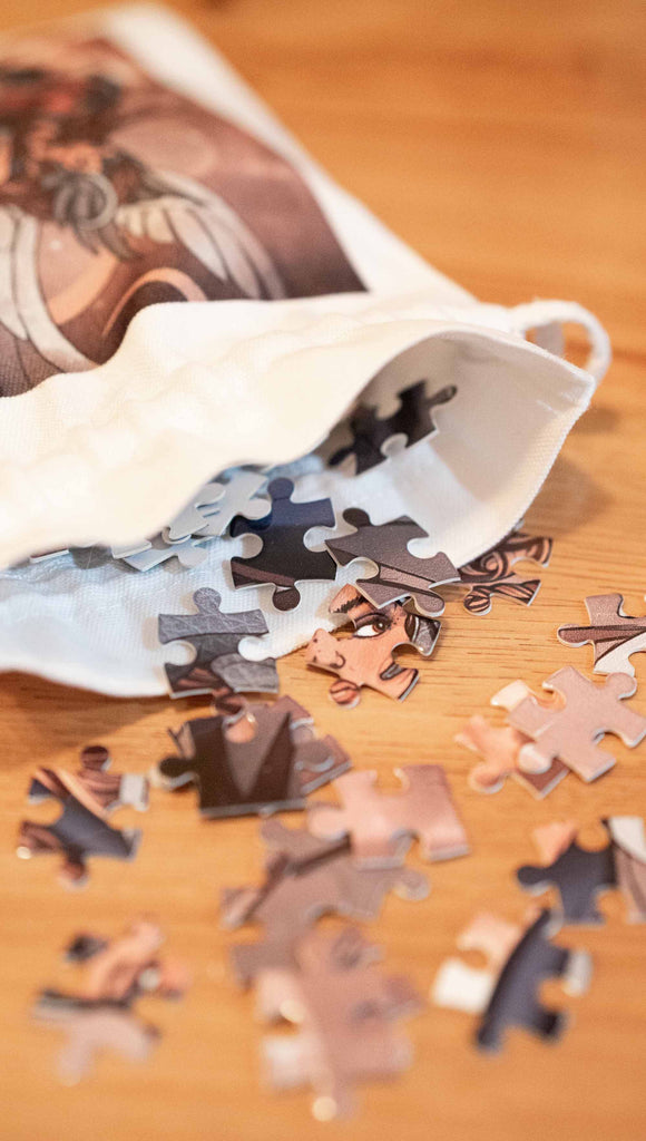 Zoomed in view of loose puzzle pieces falling out of a matching drawcord bag.