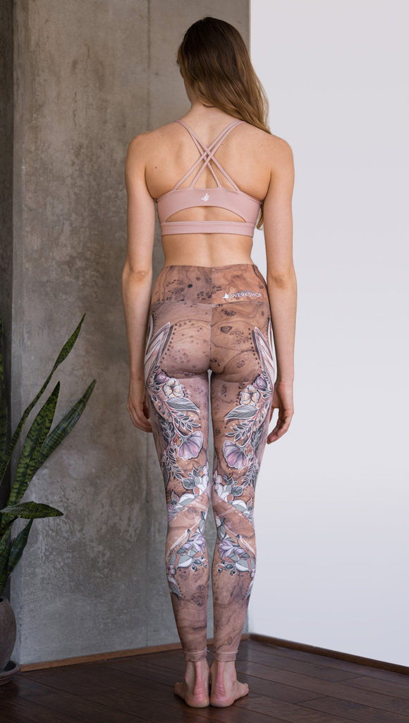closeup back view of model wearing full length leggings with printed jackalope design