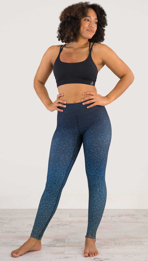 Full body front view of model wearing WERKSHOP Black Ombre Full Length Triathlon Leggings. The artwork is dark indigo blue on top and fades to a lighter blue on the bottom - with a lot of texture from bead-like artwork.
