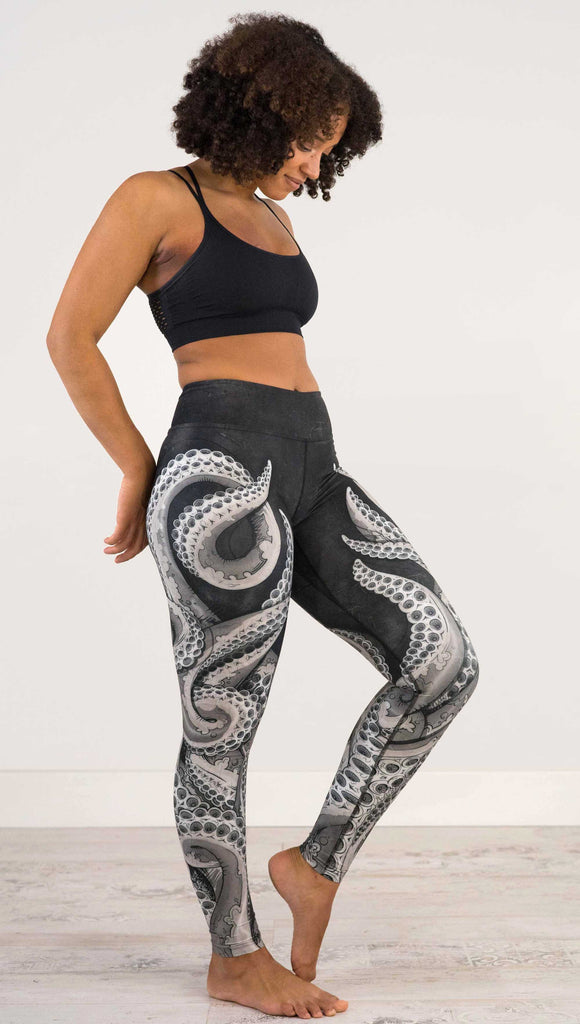 Front side view of model wearing WEKSHOP Tentacles Full Length Triathlon Leggings. The artwork is monochrome black and white and features large tentacles wrapping around the legs from the bottom reaching upward.