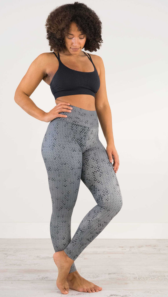 Full body side view of model wearing WERKSHOP Chainmaille Athleisure Leggings. The leggings are printed with a photo-real image of actual chainmaille. Perfect for a Renaissance Festival.