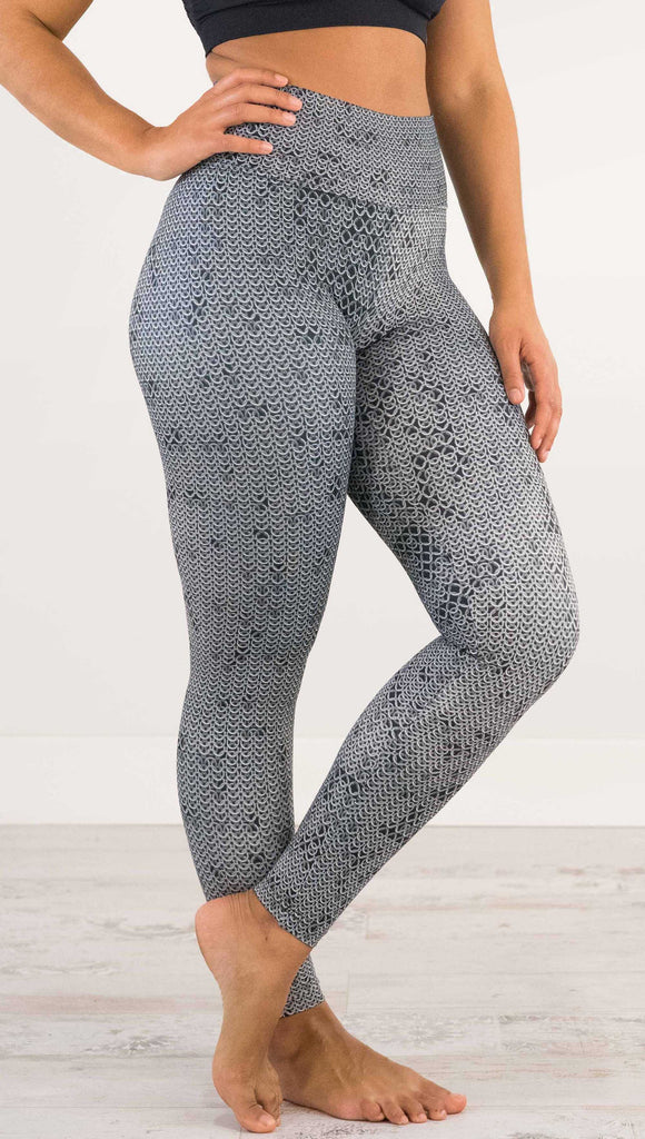 Waist down and side view of model wearing WERKSHOP Chainmaille Athleisure Leggings. The leggings are printed with a photo-real image of actual chainmaille. Perfect for a Renaissance Festival.