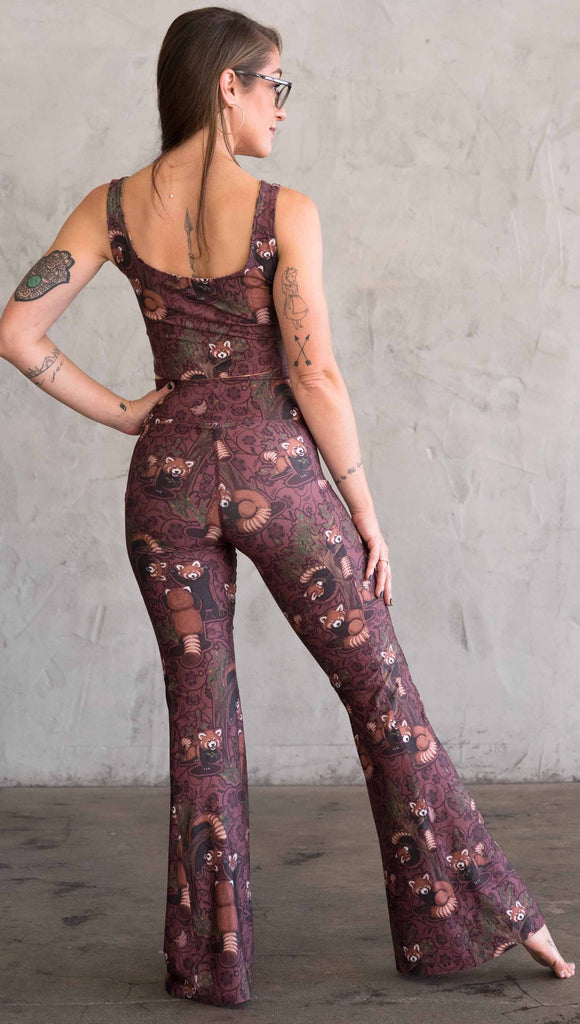 Back view of WEKSHOP red panda leggings in ultra lightweight featherlight fabric. The artwork is dark red base with clusters of cute little red pandas playing on trees and the bottoms have a large phone pocket on each leg.