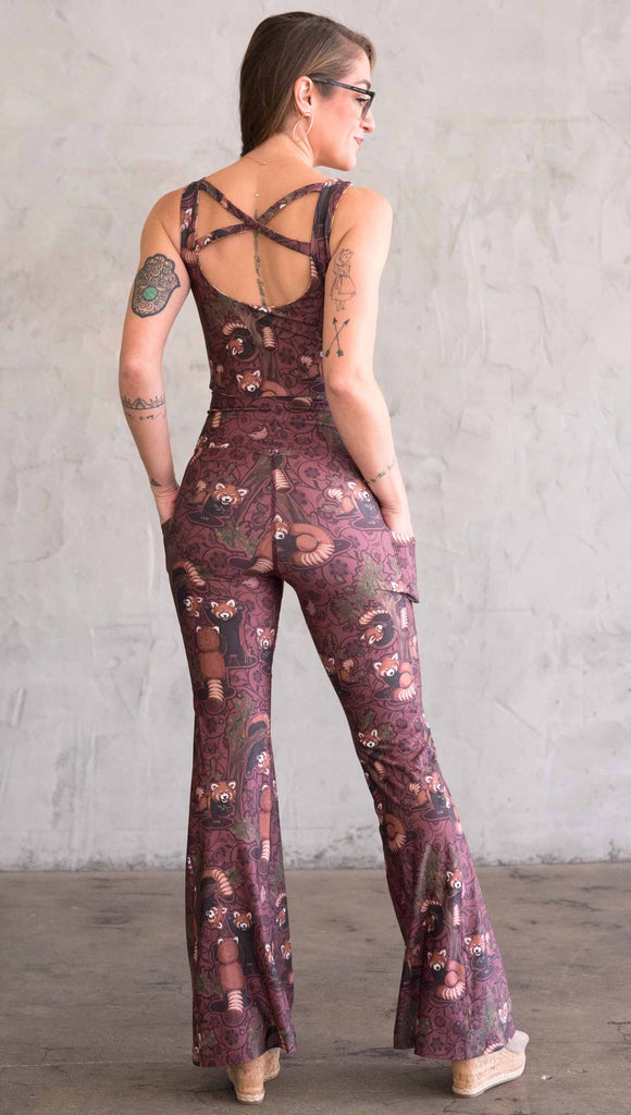 Back view of WEKSHOP red panda leggings in ultra lightweight featherlight fabric. The artwork is dark red base with clusters of cute little red pandas playing on trees and the bottoms have a large phone pocket on each leg.