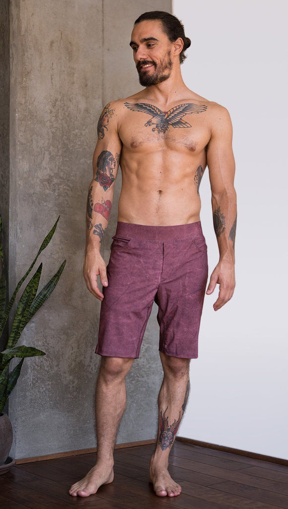 front view of model wearing brick red printed mens performance shorts