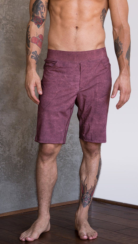 closeup front view of model wearing brick red printed mens performance shorts