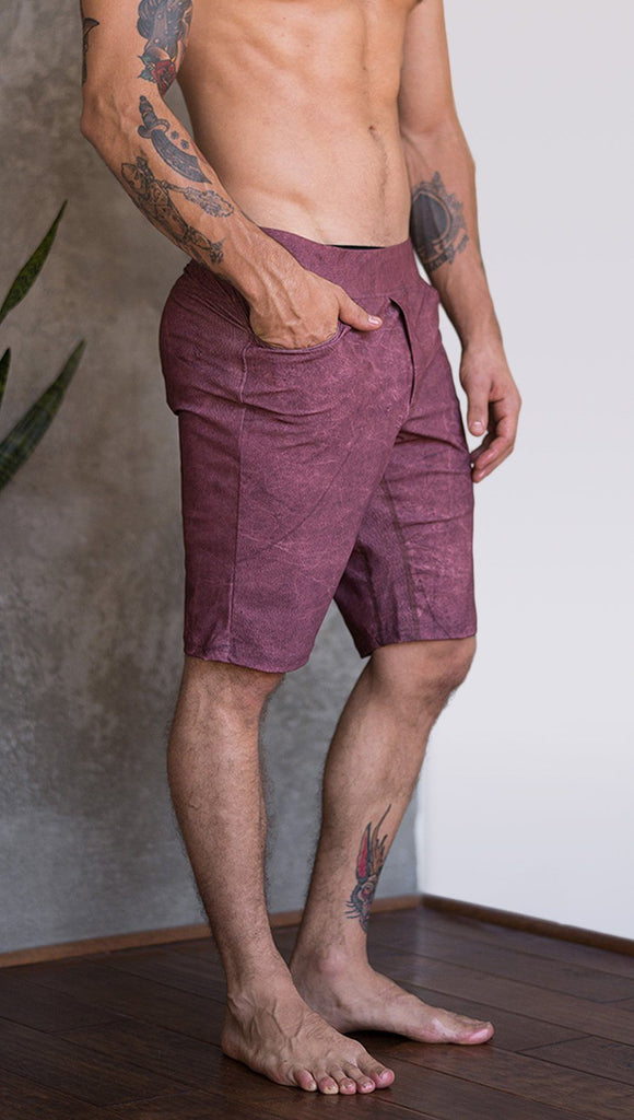 closeup right side view of model wearing brick red printed mens performance shorts