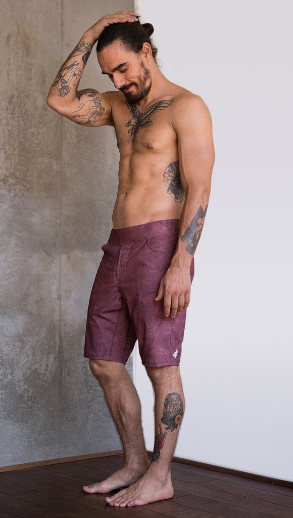 left side view of model wearing brick red printed mens performance shorts