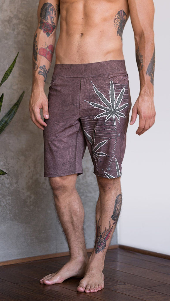 closeup front view of model wearing cannabis inspired printed mens performance shorts
