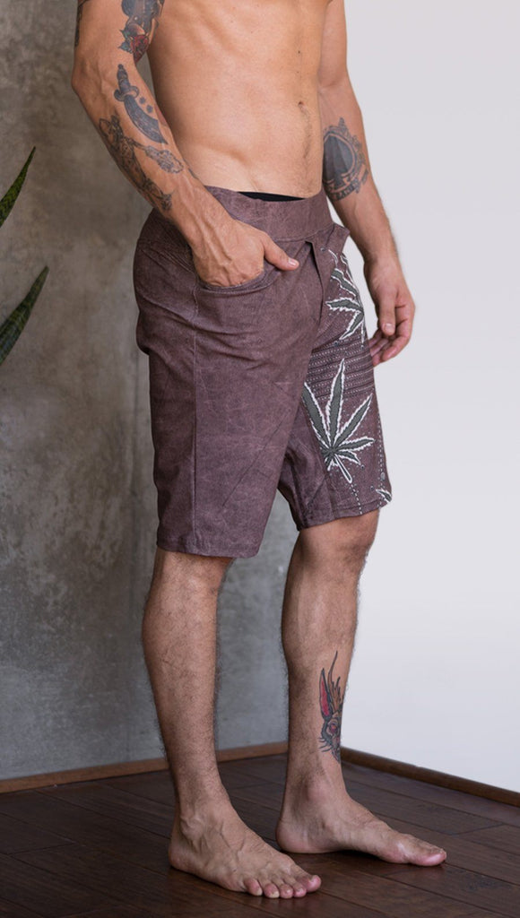 closeup right side view of model wearing cannabis inspired printed mens performance shorts