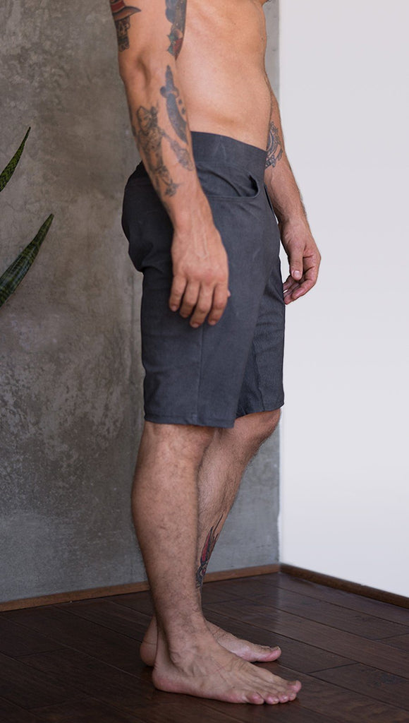 close up right side view of model wearing gray mens performance shorts