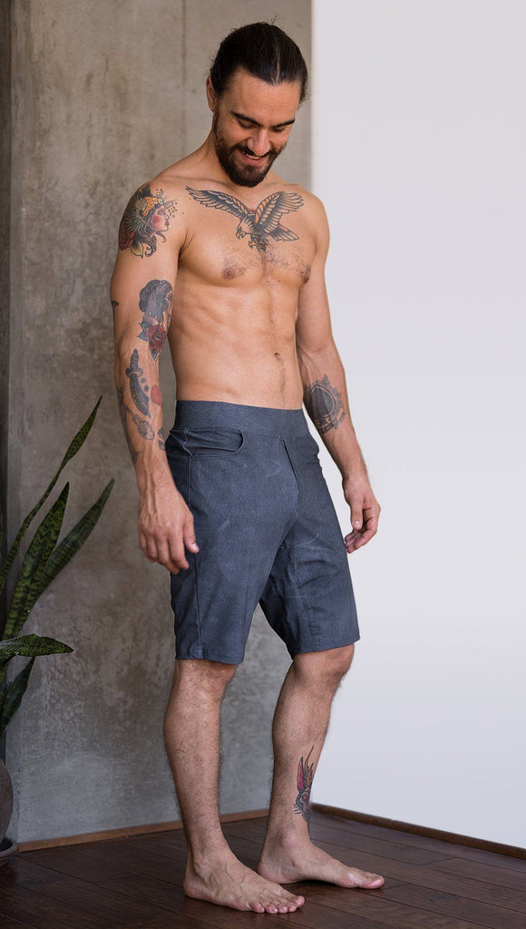 right side view of model wearing slate mens performance shorts